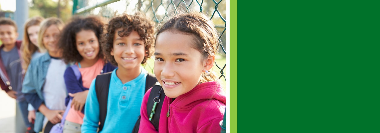 Image of kids on a playground leaving school.