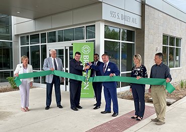 Ribbon cutting in front of new hospital