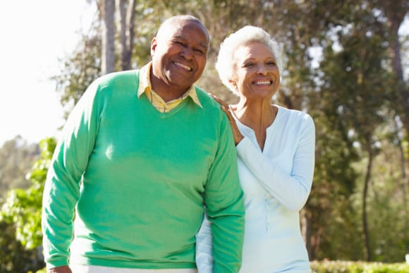 Photo of an elderly couple walking outdoors.