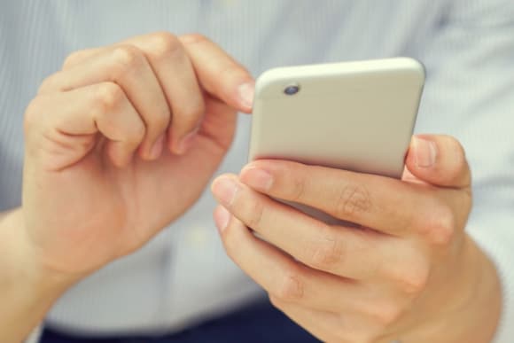 Photo of hands using smartphone.