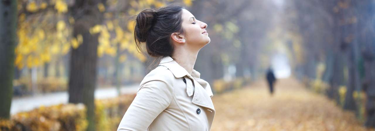 Photo of woman in park on a fall day.