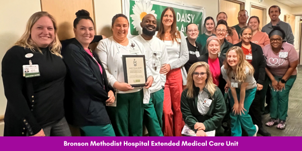 Bronson Methodist Hospital's extended medical care unit smiles while holding their DAISY Award.