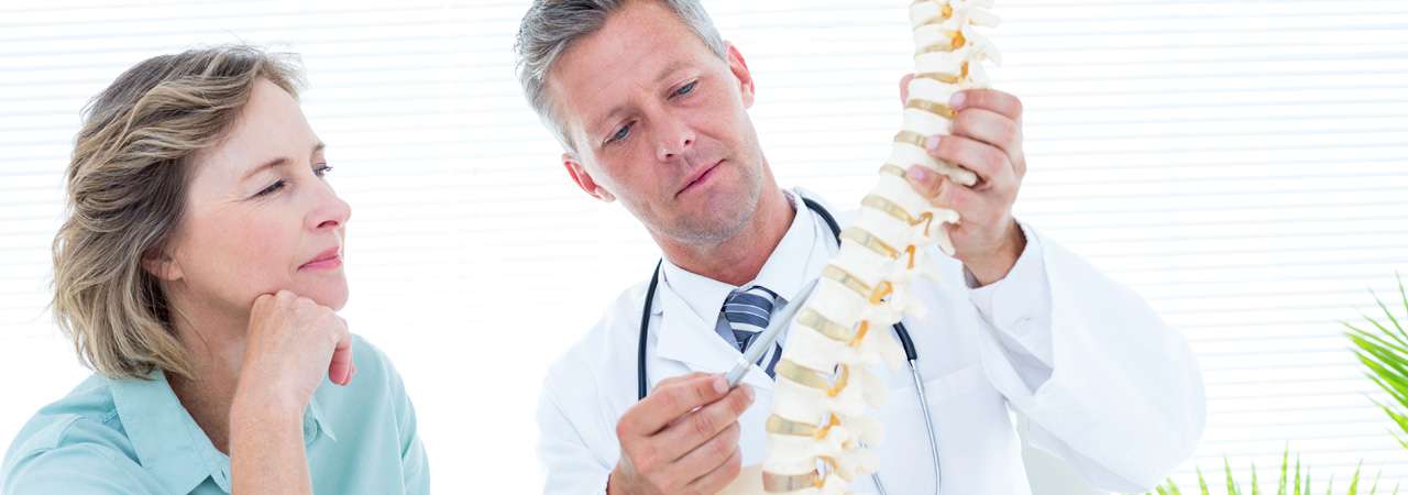 Doctor and patient looking at a spine diagram