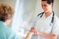 Nurse smiling and helping patient at Bronson.