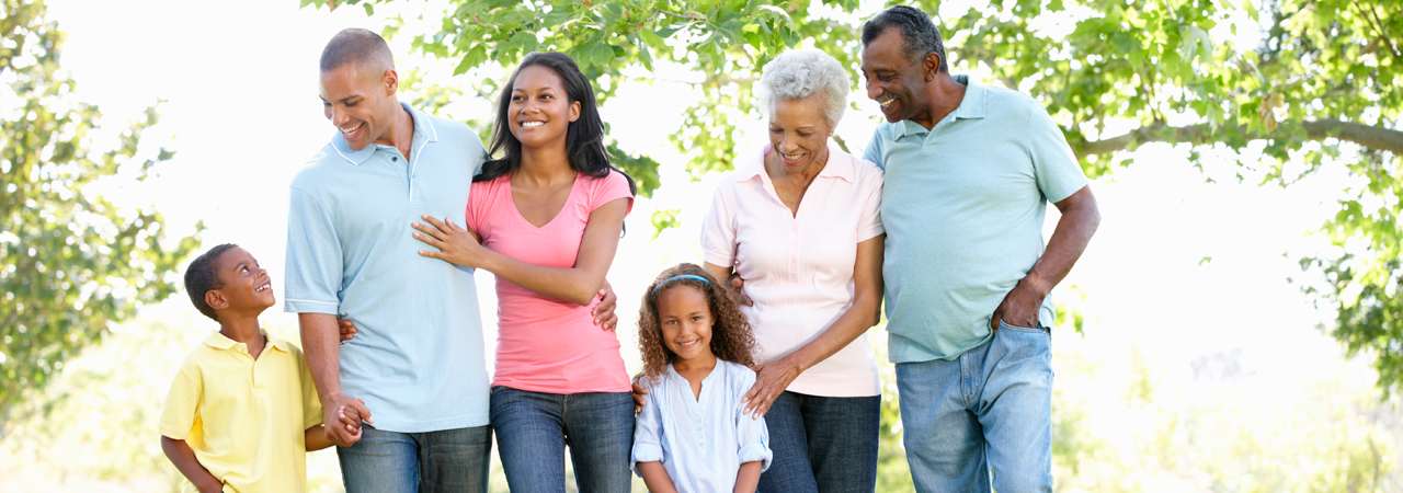 image of multi generational african american family walking in a park