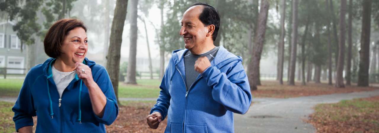 Photo of senior Hispanic couple jogging.