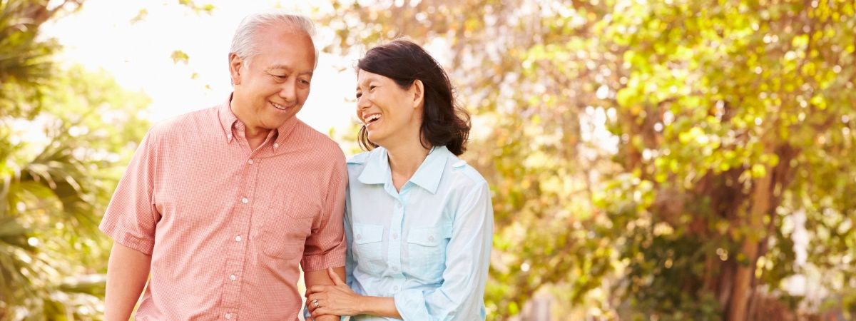 image of senior couple standing in field