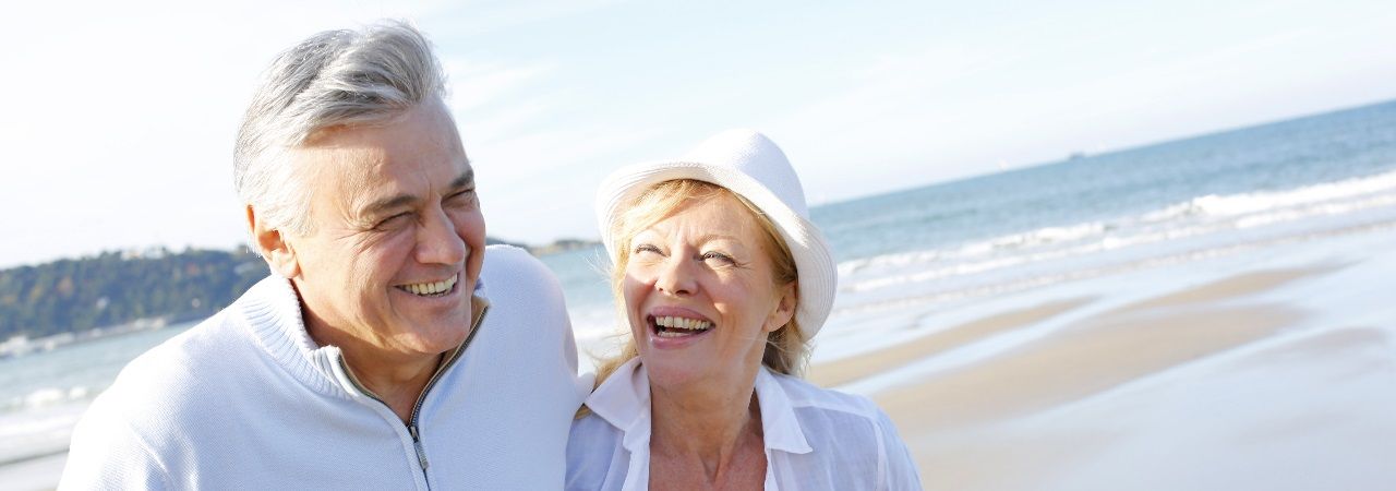 image of senior couple standing in field