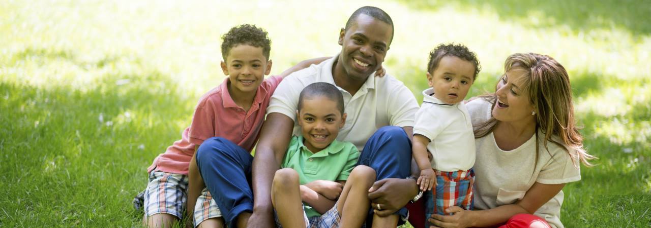 Photo of family sitting in grass.