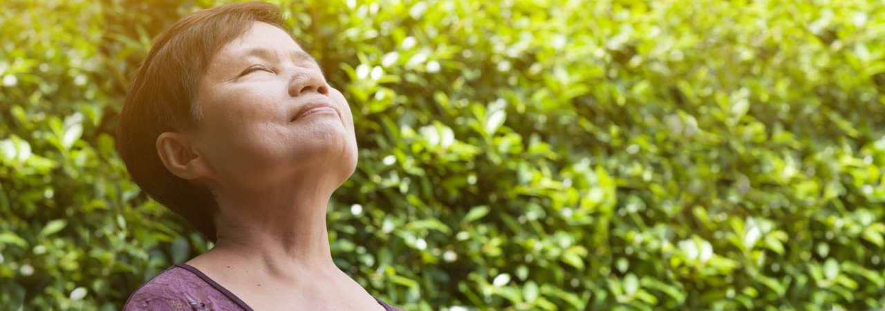 Photo of woman taking a breath outside.