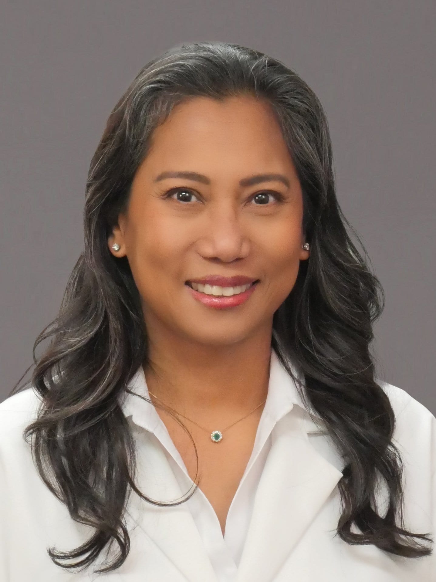 Dr. Tadian smiles for the camera in a white coat.