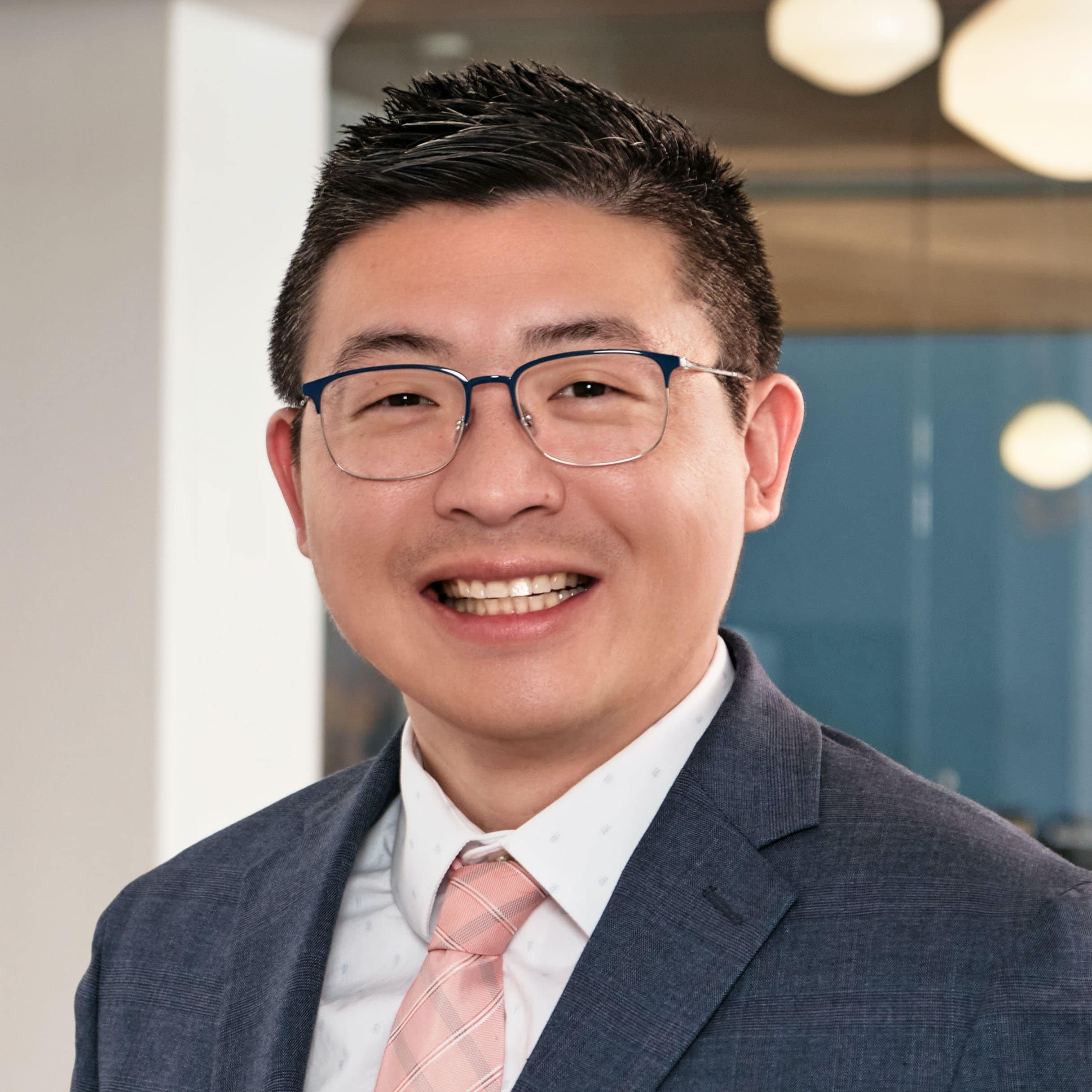 Paul Fu, MD, MBA smiles at the camera wearing a suit..