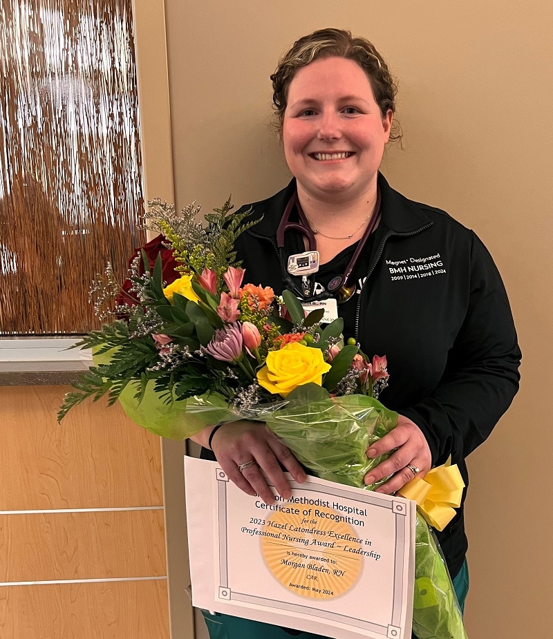 Photo of the Morgan, a Bronson cardiology nurse, smiling as she receives the Excellence in Nursing Award.