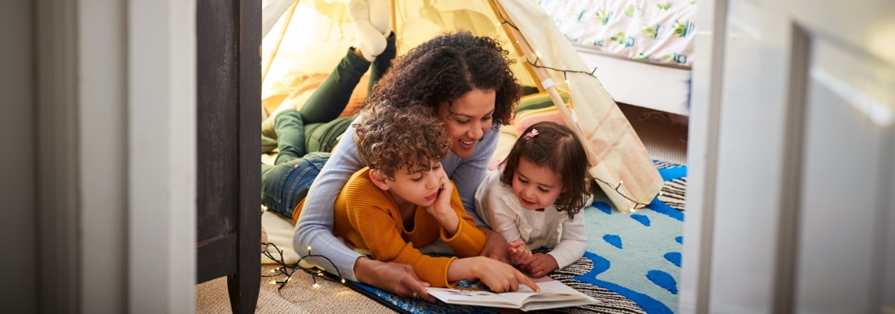 Photo of mother reading to her children.