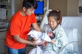 Couple holding newborn baby