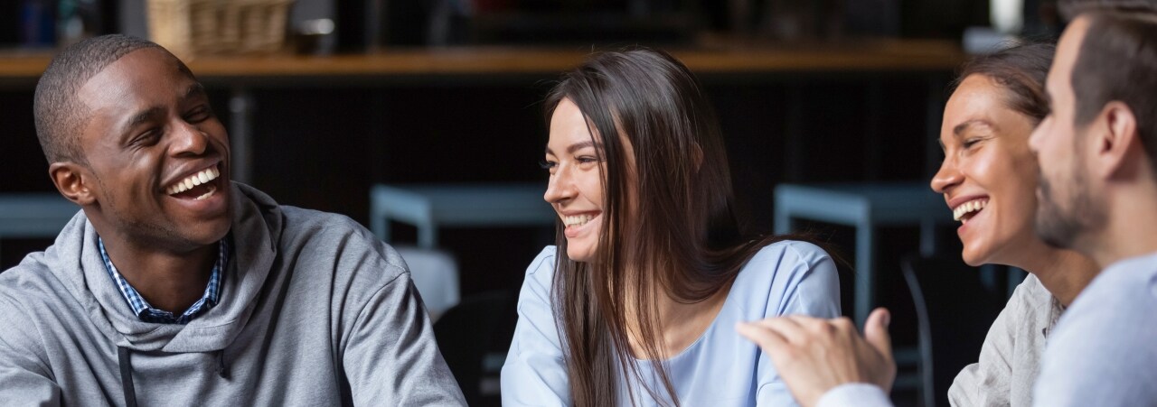 image of young adults laughing.