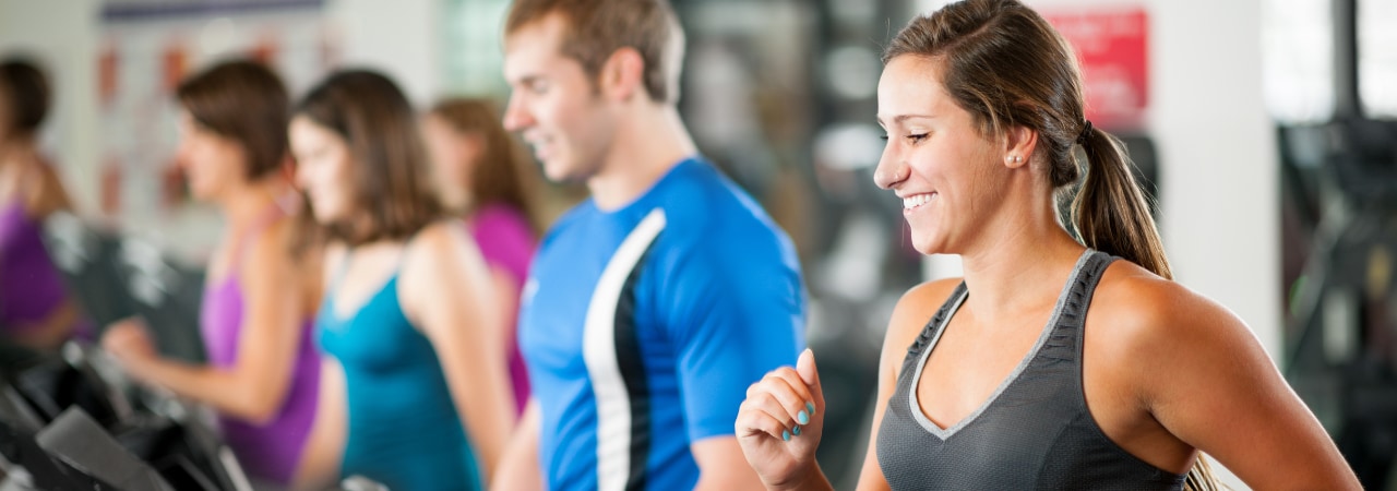 Group of people at the Bronson Wellness Center walking on treadmills.