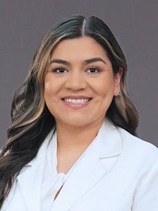 Dr. Jessica Ramirez smiles for the camera in a white coat.