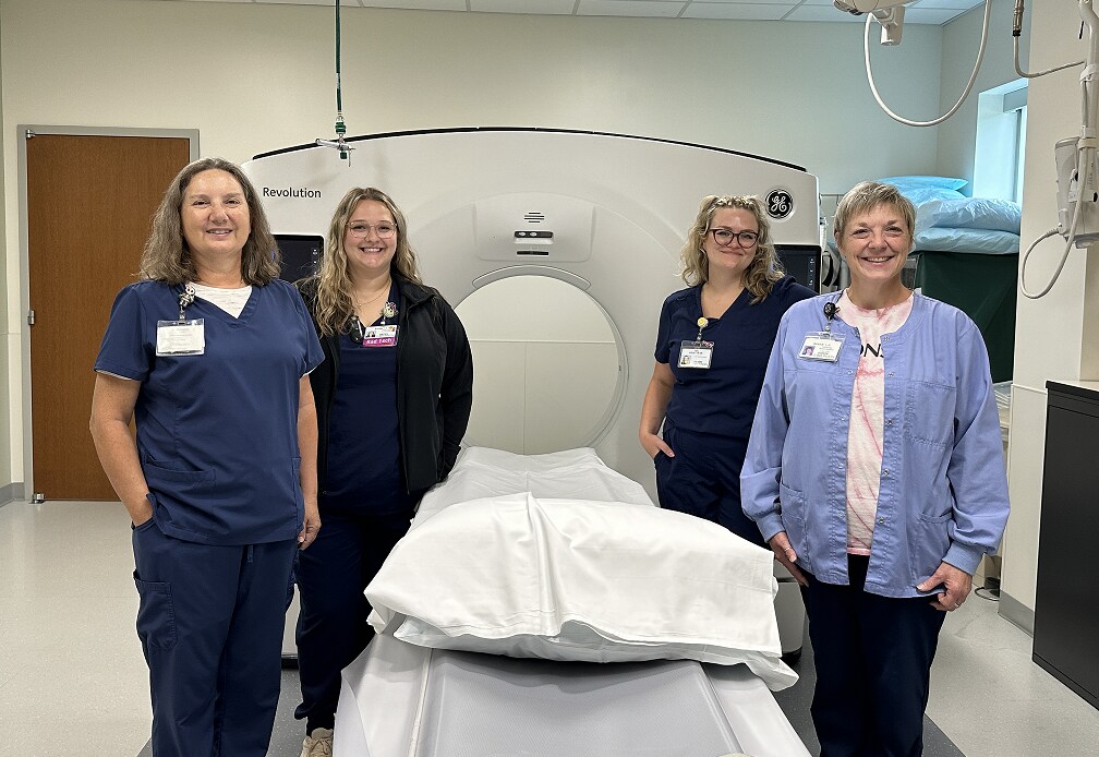 Bronson South Haven imaging team stands next to CT Scanner.