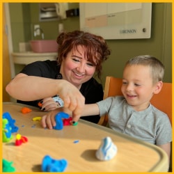 Art therapist with pediatric patient playing with clay