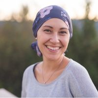 Image of a woman with cancer smiling.