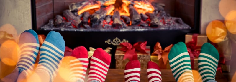 feet with socks by fireplace