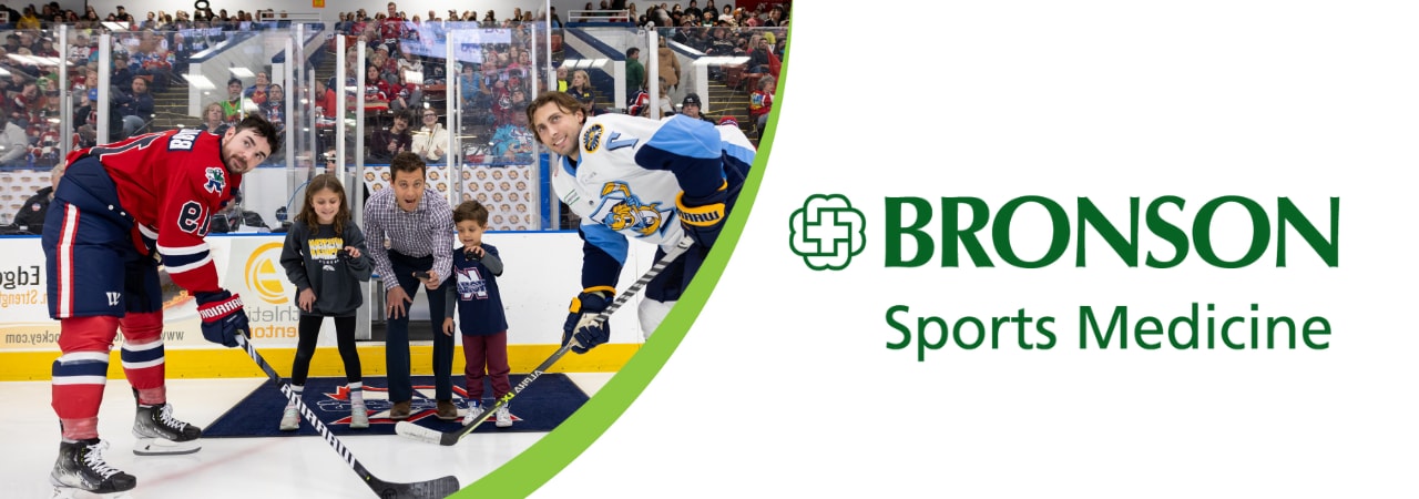 Photo of Dr. Bronsteen dropping the puck at a K Wings game. 