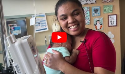 Mom holding baby in NICU.