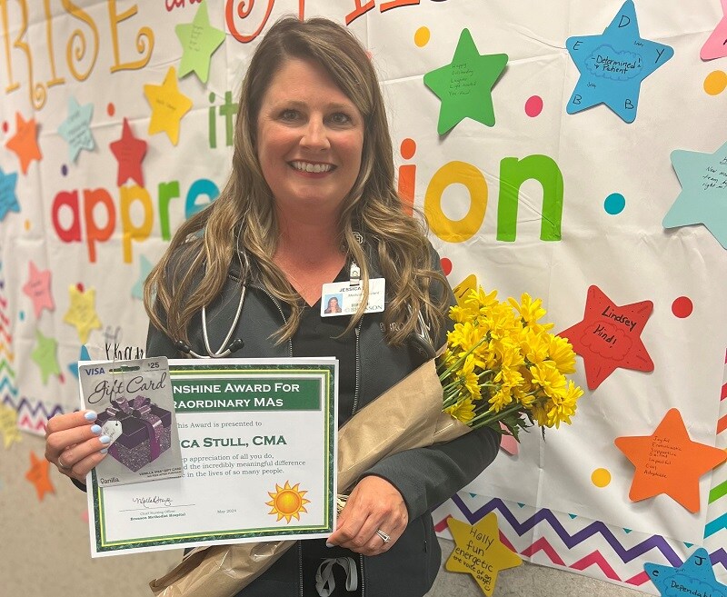 Photo of the Jessica, a medical assistant at Bronson, smiling as she recieves her Sunshine Award.