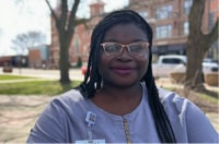 LaShawnda Bates sitting at picnic table in downtown Battle Creek. 