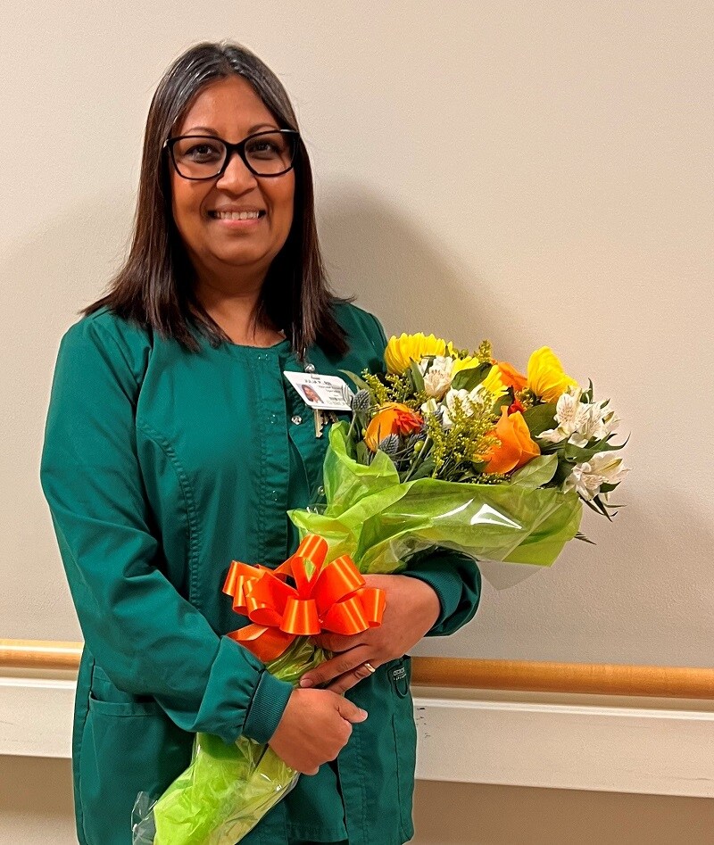 Photo of the Julia, a nurse at Bronson, smiling as she recieves her Excellence in Nursing award.