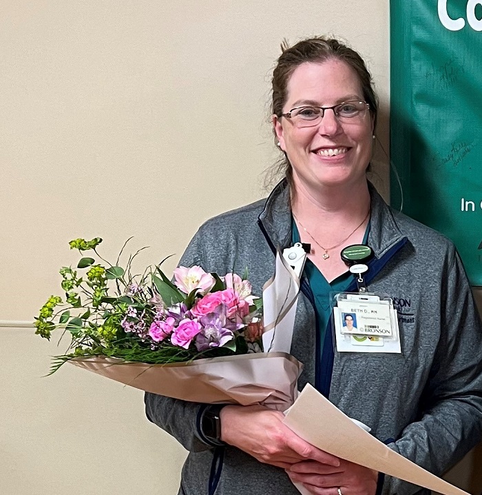 Beth Dorr, a Bronson Battle Creek ED Nurse, standing for a photo as she receives the 2024 Excellence in Nursing Award.