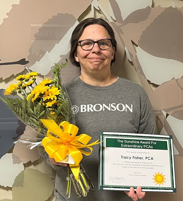 Tracy, a patient care assistant at Bronson LakeView Hospital, smiles as she receives the Sunshine Award.