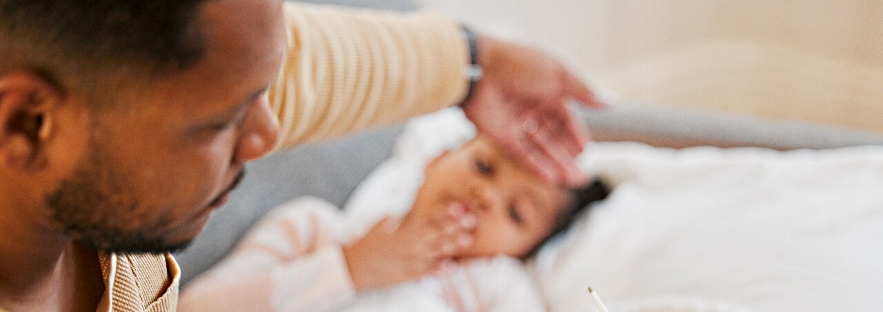 Dad with Daughter Checking Temperature