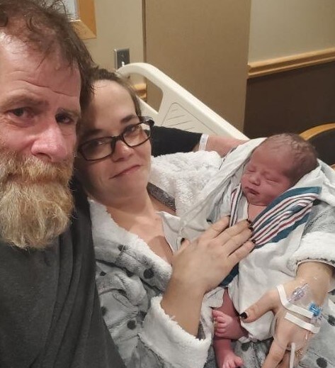 Photo of new year baby and parents.